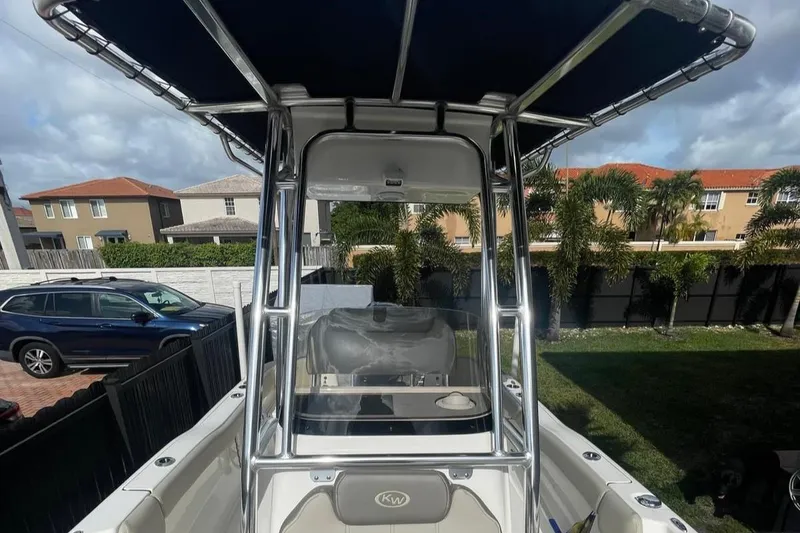 Slide: The Image of 2024 Key West 203 FS boat with T-top, parked in residential area. - 4