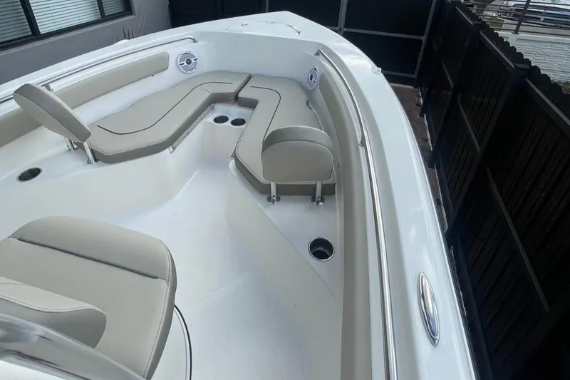 Slide: The Image of 2024 Key West 203 FS boat interior with beige seating and cup holders. - 5
