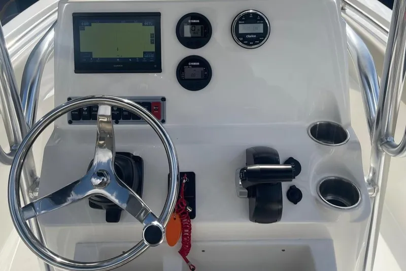 Slide: The Image of 2024 Key West 203 FS boat dashboard with steering wheel, controls, and navigation display. - 7