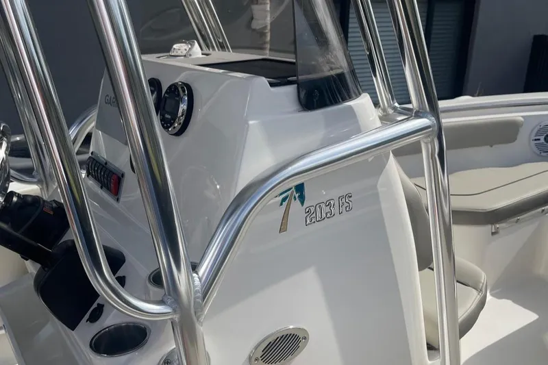 Slide: The Image of 2024 Key West 203 FS boat console with stainless steel railings and modern controls. - 8
