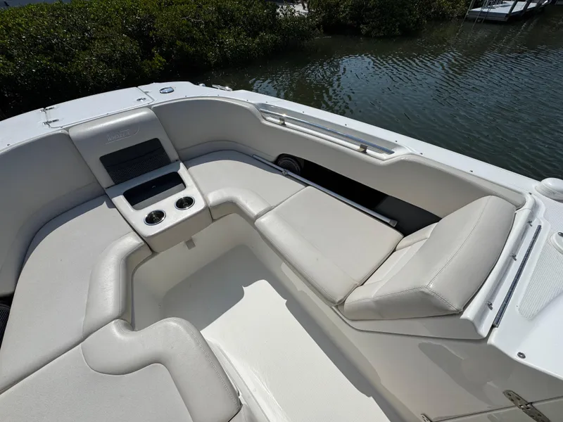 Slide: The Image of 2018 Boston Whaler 270 Vantage boat interior with cushioned seating and cup holders. - 11