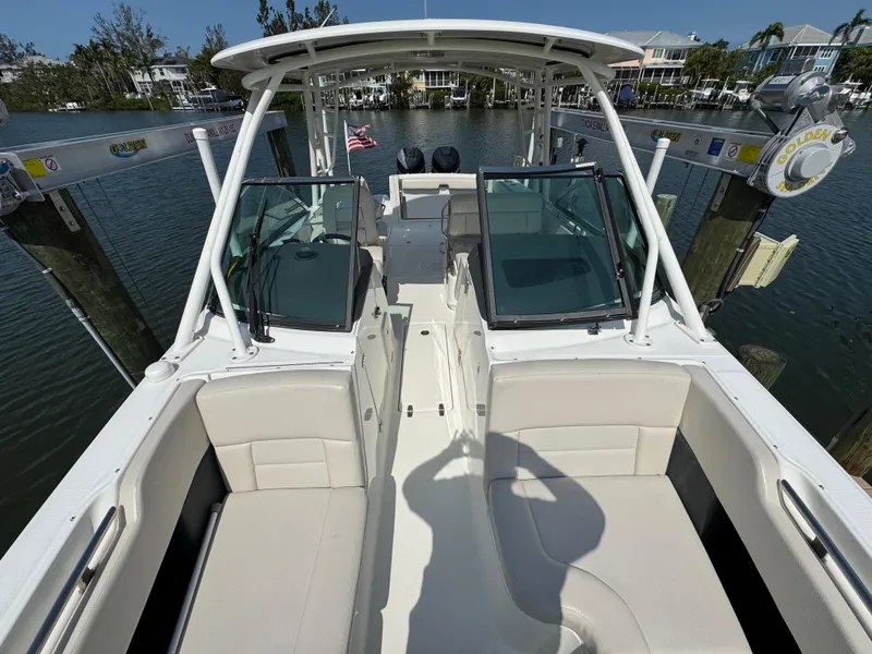 Slide: The Image of 2018 Boston Whaler 270 Vantage boat interior with seating and dual consoles. - 13