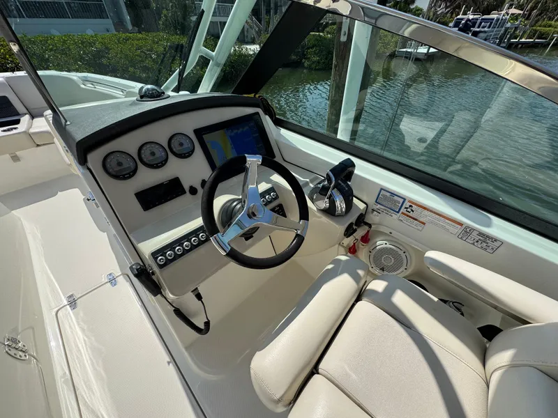Slide: The Image of 2018 Boston Whaler 270 Vantage boat cockpit with steering wheel and control panel. - 15