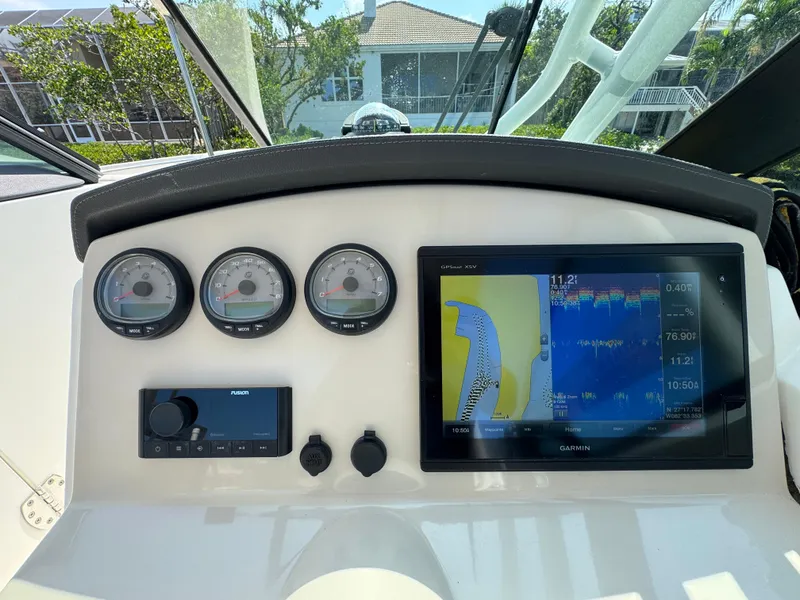 Slide: The Image of Dashboard of 2018 Boston Whaler 270 Vantage with gauges and Garmin navigation display. - 16