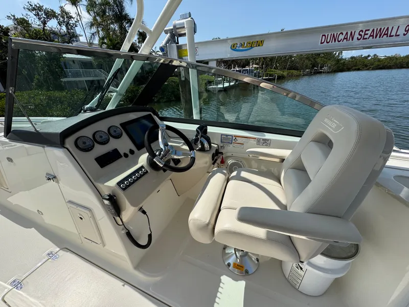 Slide: The Image of 2018 Boston Whaler 270 Vantage boat cockpit with steering wheel and control panel. - 19