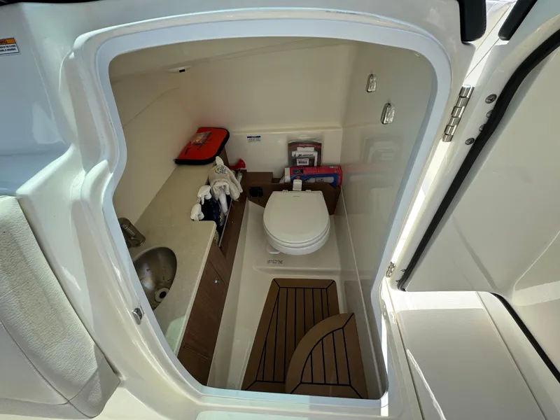 Slide: The Image of 2018 Boston Whaler 270 Vantage boat interior with compact bathroom and sink. - 23