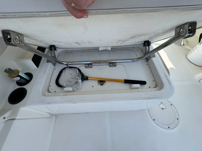 Slide: The Image of Open storage compartment on 2018 Boston Whaler 270 Vantage with fishing net inside. - 28