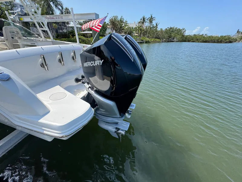 Slide: The Image of 2018 Boston Whaler 270 Vantage with dual Mercury outboard engines on a calm lake. - 33