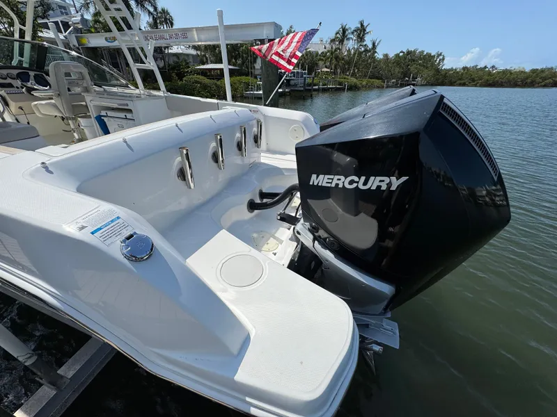 Slide: The Image of 2018 Boston Whaler 270 Vantage boat with Mercury engine, docked by water. - 34