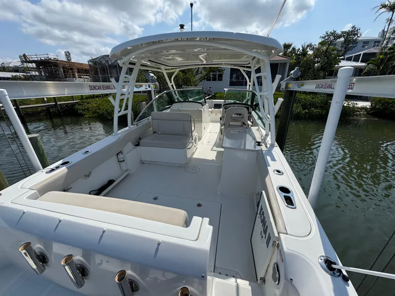 Slide: The Image of 2018 Boston Whaler 270 Vantage boat docked, featuring spacious seating and sleek design. - 7