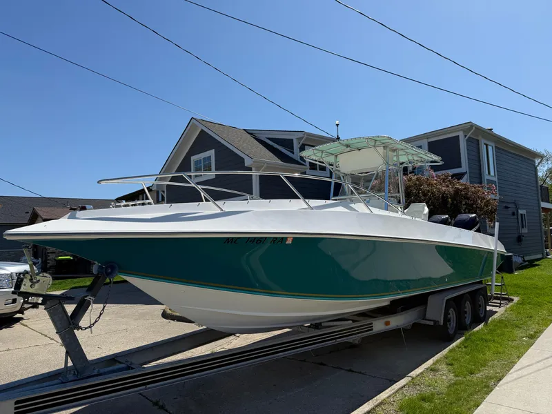 Slide: The Image of 1994 Fountain 31 Tournament Edition boat on trailer, parked in residential area. - 1