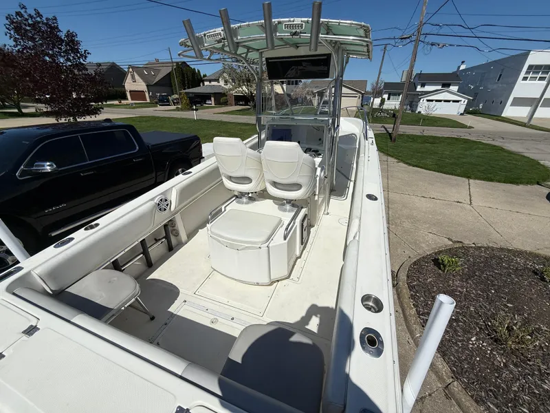 Slide: The Image of 1994 Fountain 31 Tournament Edition boat with dual seats and center console, parked in a residential area. - 13