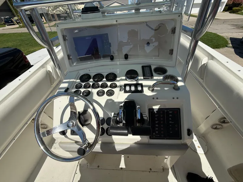 Slide: The Image of Control panel of a 1994 Fountain 31 Tournament Edition boat with steering wheel and gauges. - 14