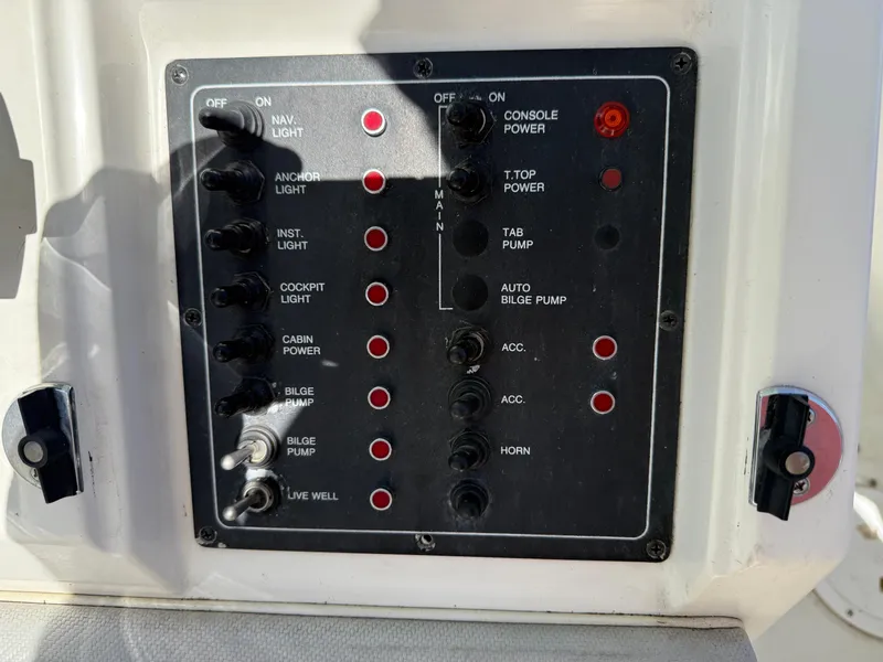 Slide: The Image of Control panel of a 1994 Fountain 31 Tournament Edition boat with various switches and indicators. - 15