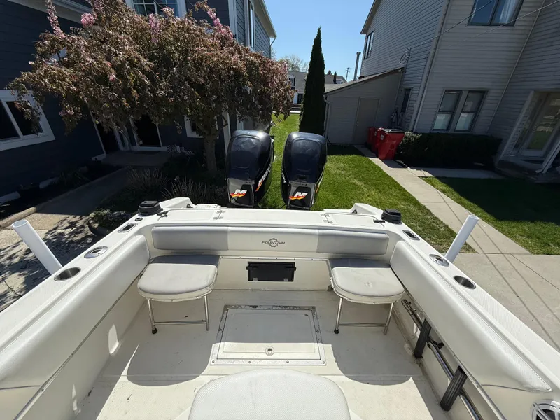 Slide: The Image of 1994 Fountain 31 Tournament Edition boat with dual engines, parked in a residential area. - 17