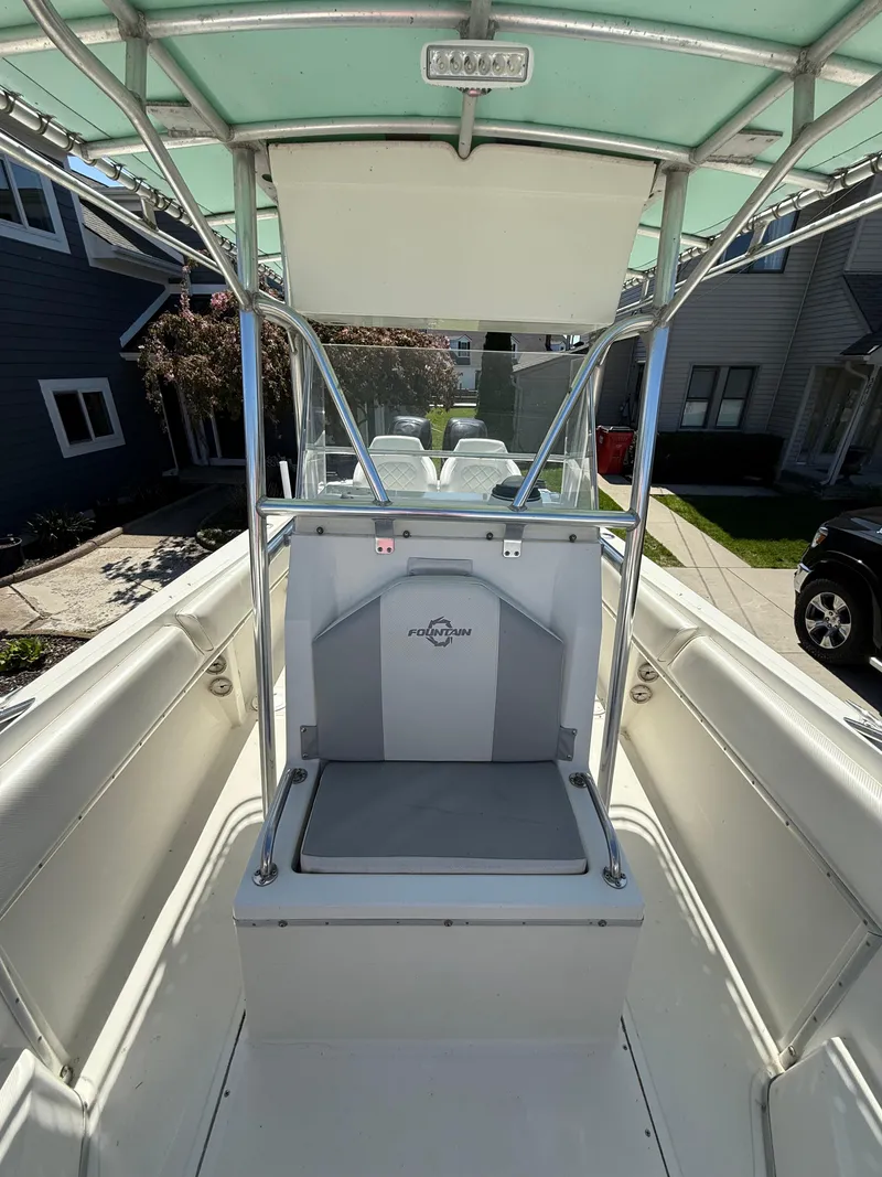 Slide: The Image of 1994 Fountain 31 Tournament Edition boat with center console and seating, docked in a residential area. - 20