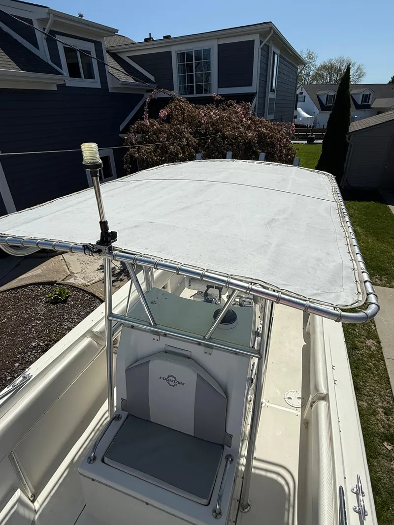 Slide: The Image of 1994 Fountain 31 Tournament Edition boat with T-top, parked in residential area. - 21