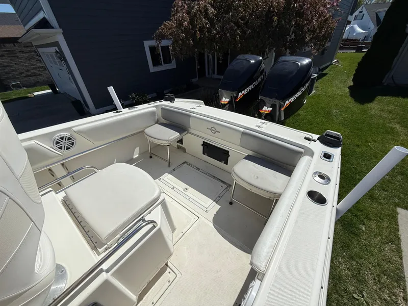 Slide: The Image of 1994 Fountain 31 Tournament Edition boat interior with seating and dual outboard motors. - 23