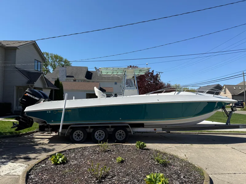 Slide: The Image of 1994 Fountain 31 Tournament Edition boat on trailer in residential driveway. - 3