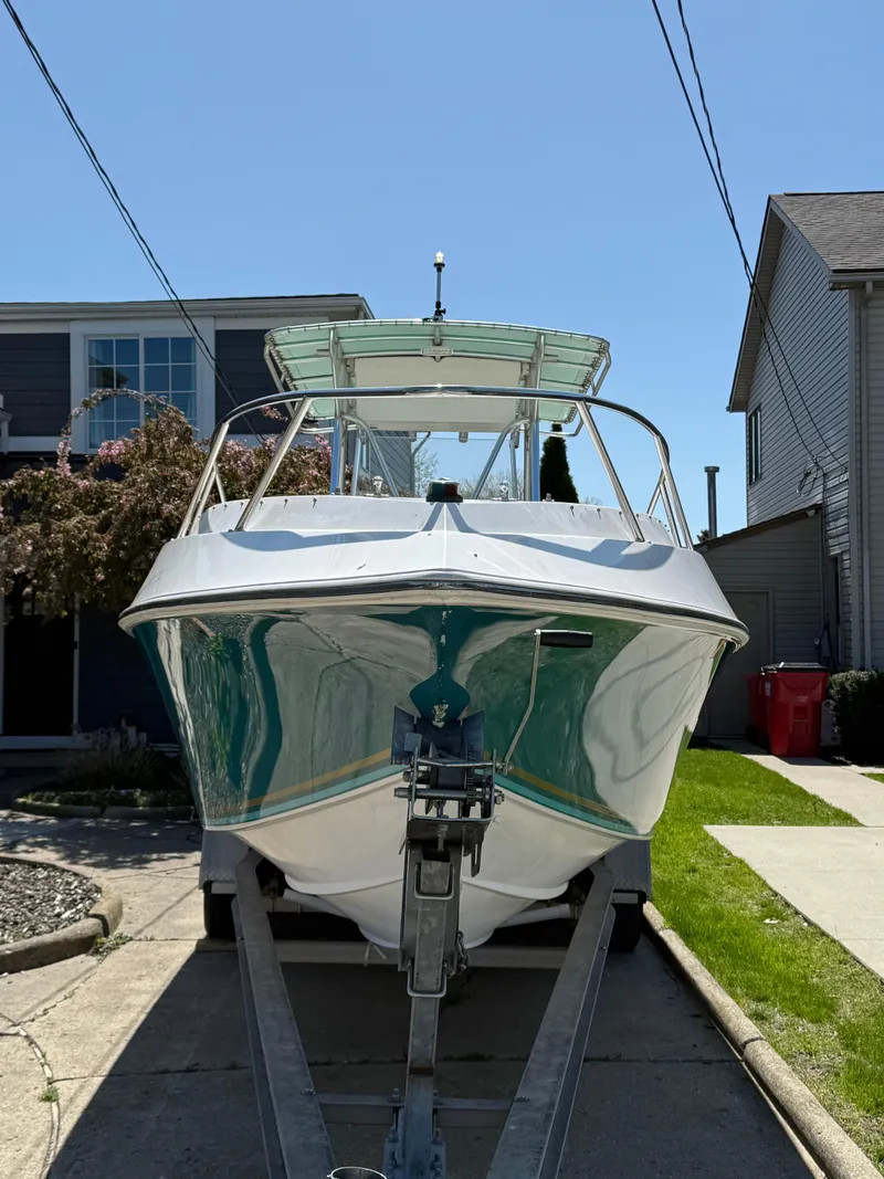 Slide: The Image of 1994 Fountain 31 Tournament Edition boat on trailer in residential driveway. - 32