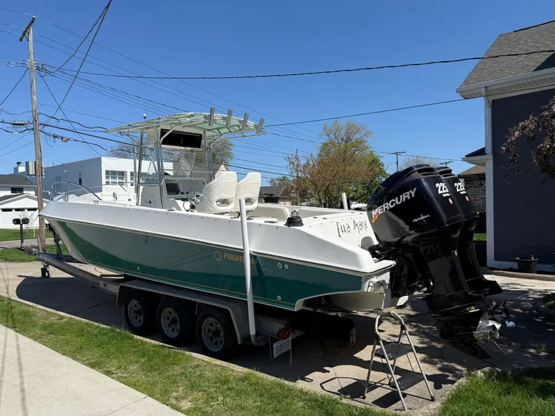 Slide: The Image of 1994 Fountain 31 Tournament Edition boat with Mercury outboard engines on a trailer. - 4