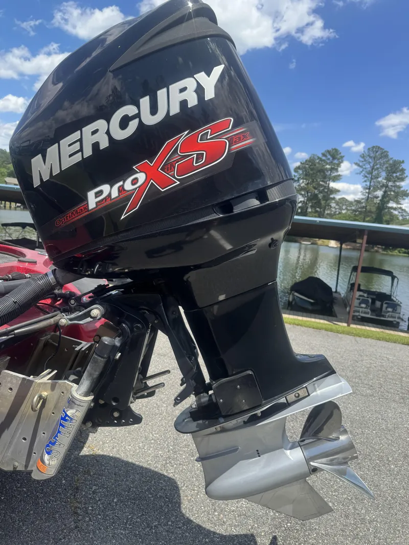 Slide: The Image of Mercury Pro XS outboard motor on a 2016 Nitro Z20 boat by a lake. - 12