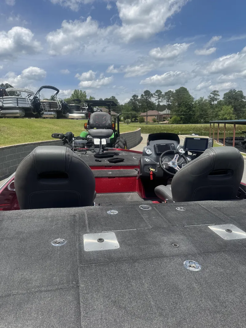 Slide: The Image of 2016 Nitro Z20 boat interior with dual seats and control panel under a cloudy sky. - 6