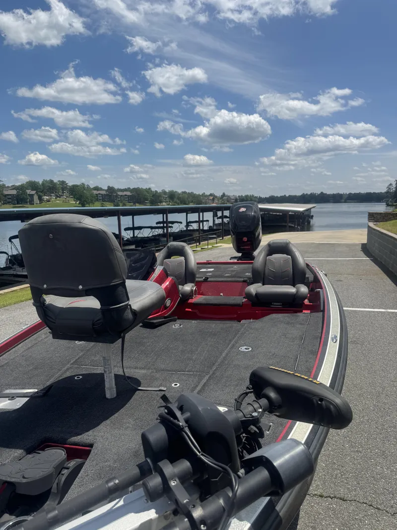 Slide: The Image of 2016 Nitro Z20 boat at a lakeside dock under a clear blue sky. - 7