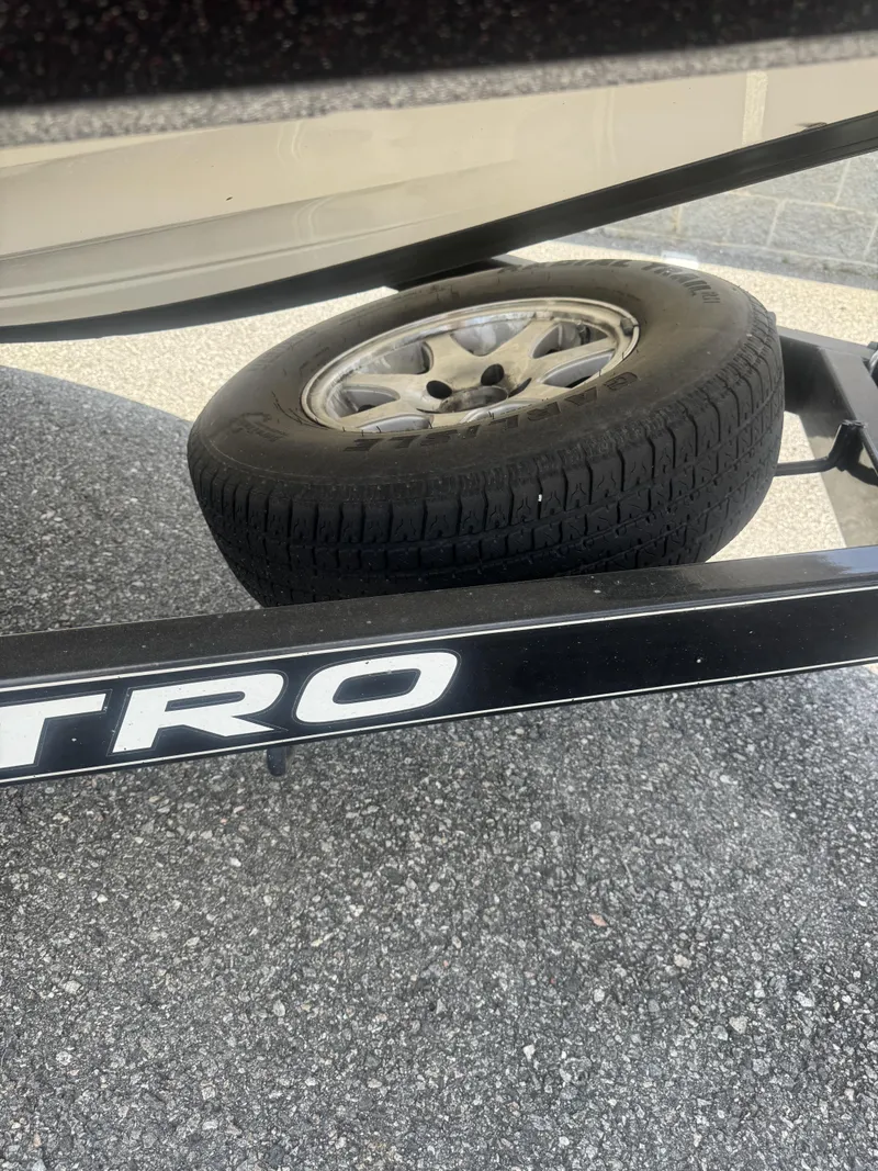 Slide: The Image of Trailer with spare tire for 2016 Nitro Z20 boat on asphalt surface. - 8