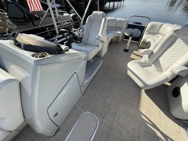 Slide: The Image of 2019 Crestliner 220 Rally DX Center Walk-through boat interior with plush seating and helm. - 12