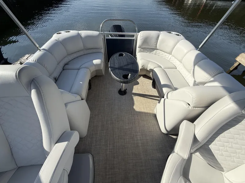 Slide: The Image of 2019 Crestliner 220 Rally DX CW boat interior with plush seating and center table. - 13
