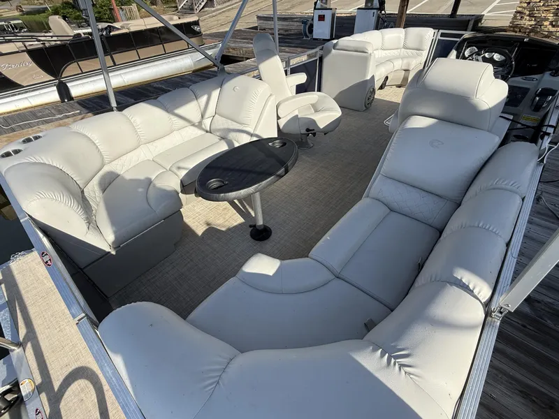 Slide: The Image of 2019 Crestliner 220 Rally DX CW boat interior with plush seating and central table. - 4