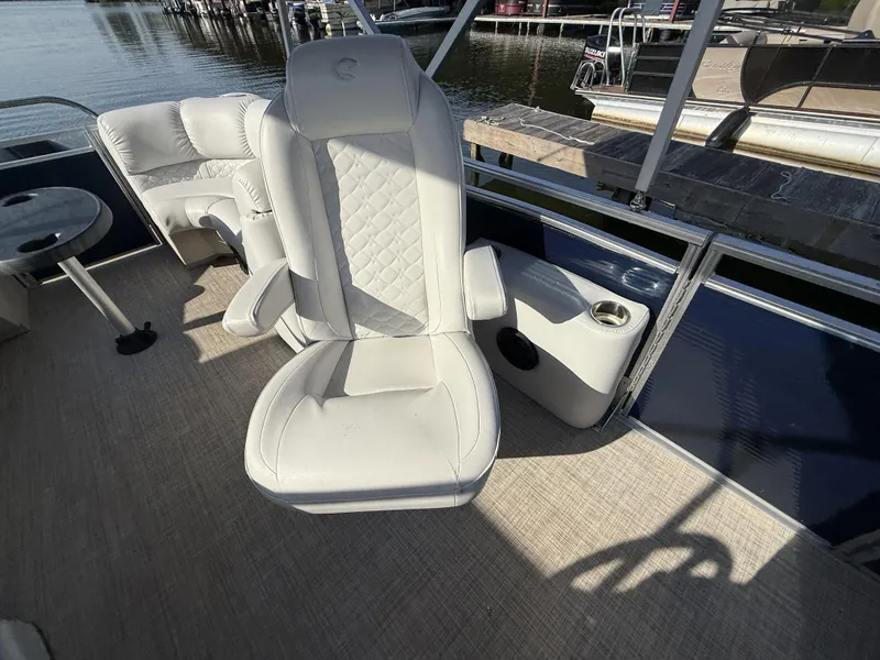 Slide: The Image of 2019 Crestliner 220 Rally DX boat interior with white seating and cup holder. - 7