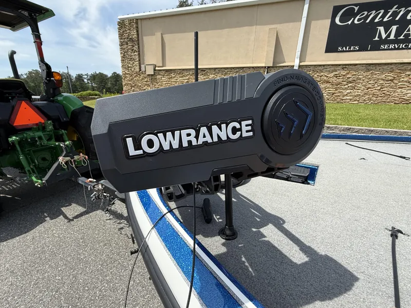 Slide: The Image of Lowrance equipment on a 2022 Nitro Z20 Pro boat, parked near a tractor. - 5