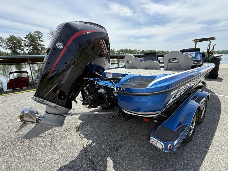 Slide: The Image of Blue 2022 Nitro Z20 Pro boat with powerful outboard motor, parked near a lake. - 8