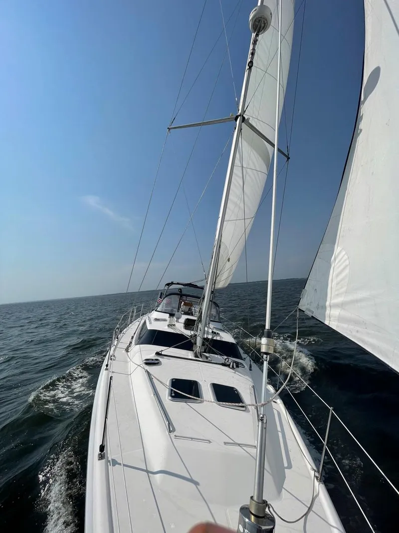 Slide: The Image of 2009 Hunter 50 Center Cockpit sailboat navigating open waters under clear skies. - 10