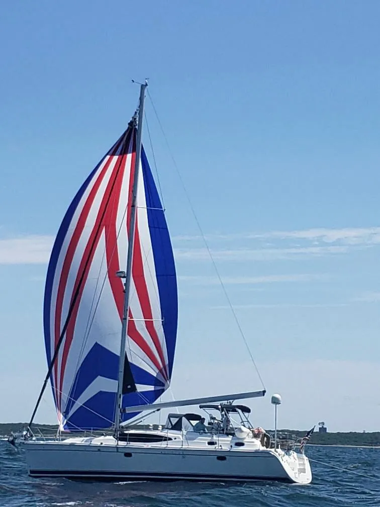 Slide: The Image of 2009 Hunter 50 Center Cockpit sailboat with colorful spinnaker on open water. - 11