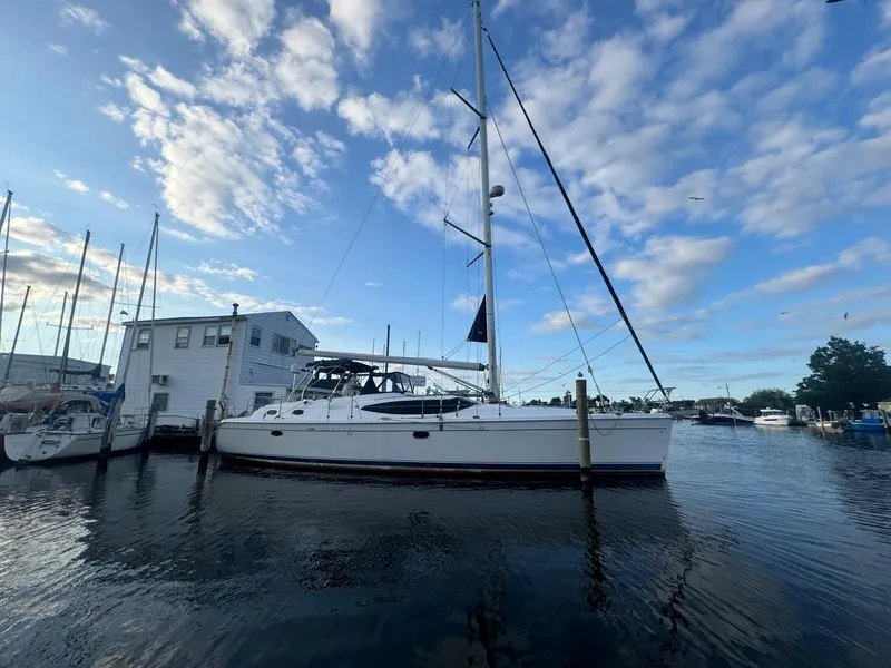Slide: The Image of Hunter 50 Center Cockpit sailboat docked, 2009 model, under a partly cloudy sky. - 12