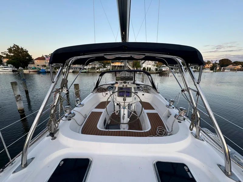 Slide: The Image of Hunter 50 Center Cockpit sailboat, 2009 model, docked in a serene marina setting. - 13