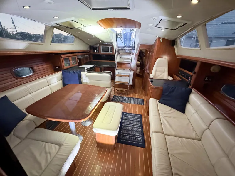 Slide: The Image of Luxurious interior of a 2009 Hunter 50 Center Cockpit yacht with elegant seating and dining area. - 14