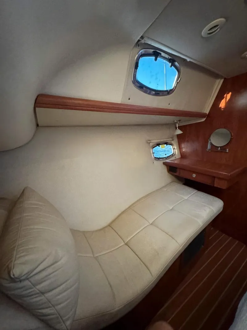 Slide: The Image of 2009 Hunter 50 Center Cockpit interior with cozy seating and porthole windows. - 21