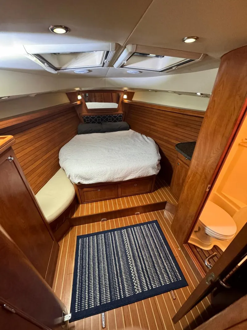 Slide: The Image of Luxurious 2009 Hunter 50 Center Cockpit interior with cozy bed and wooden finish. - 22
