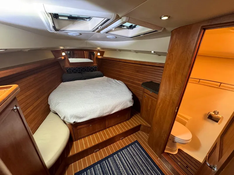 Slide: The Image of Luxurious 2009 Hunter 50 Center Cockpit interior with cozy bed and wooden finish. - 23
