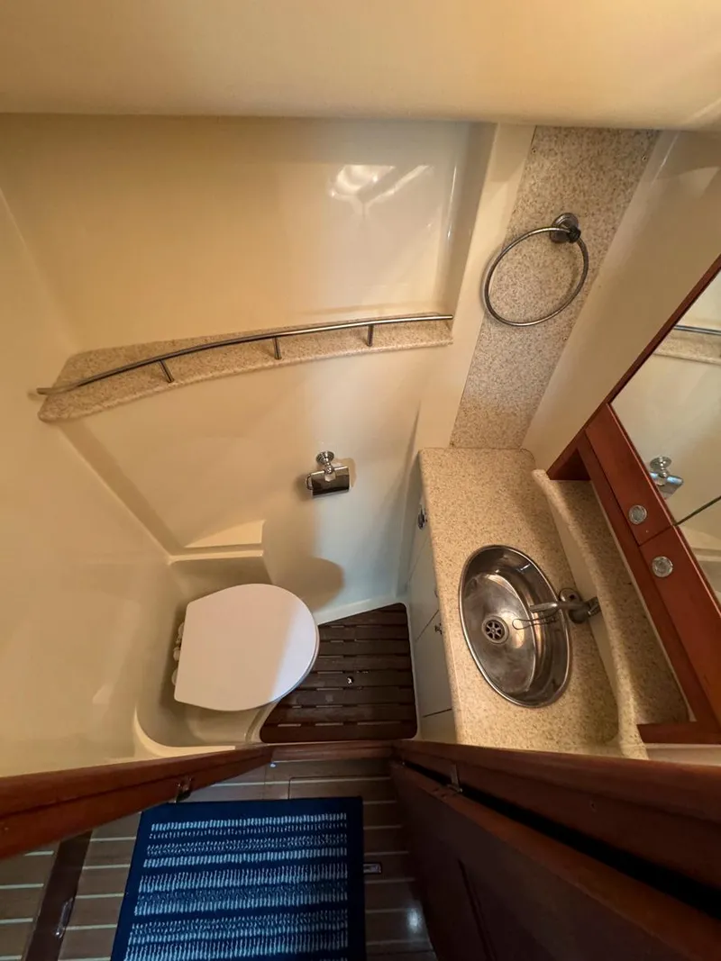 Slide: The Image of 2009 Hunter 50 Center Cockpit bathroom with sink, toilet, and mirror. - 24