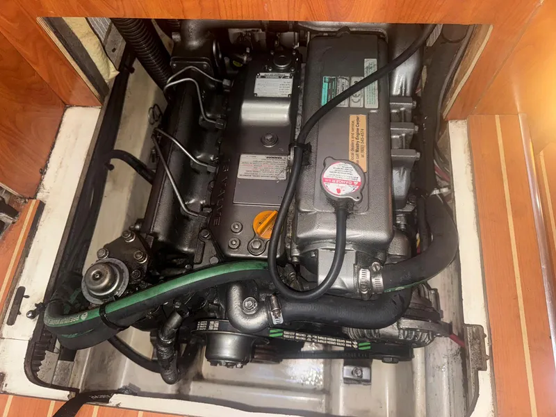 Slide: The Image of Engine compartment of a 2009 Hunter 50 Center Cockpit sailboat, showcasing mechanical components. - 25