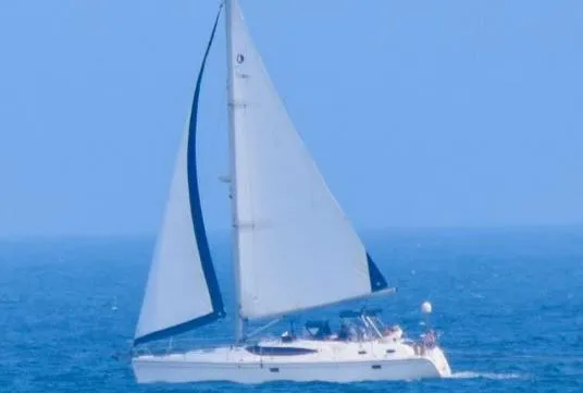 Slide: The Image of 2009 Hunter 50 Center Cockpit sailboat cruising on open sea under clear blue skies. - 3