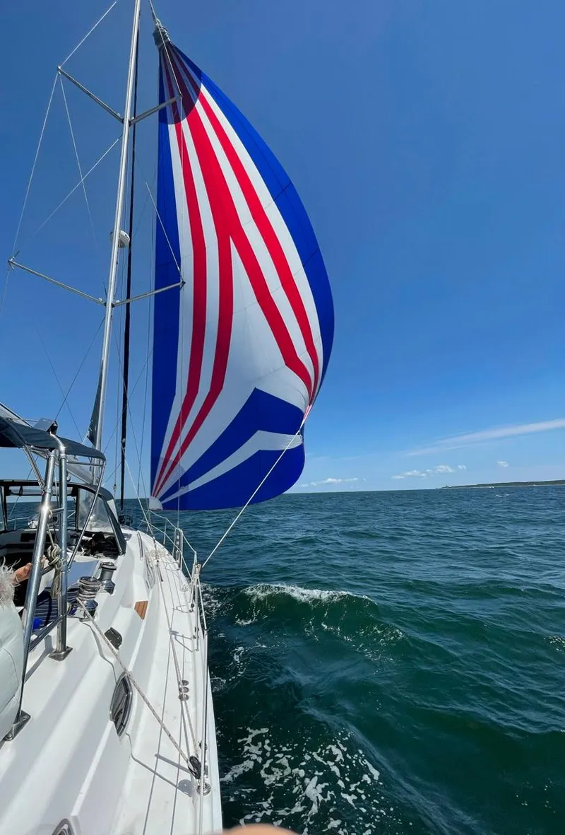 Slide: The Image of Sailing on a 2009 Hunter 50 Center Cockpit with vibrant spinnaker on open sea. - 4