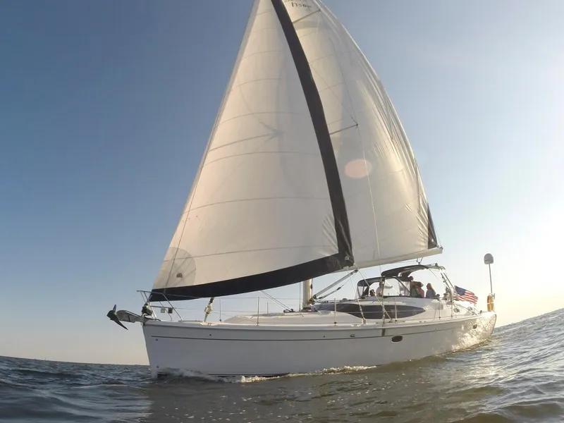 Slide: The Image of 2009 Hunter 50 Center Cockpit sailboat gliding on open water under clear skies. - 5