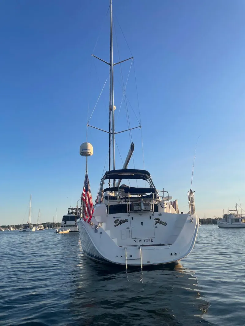 Slide: The Image of 2009 Hunter 50 Center Cockpit sailboat on calm water at sunset. - 7