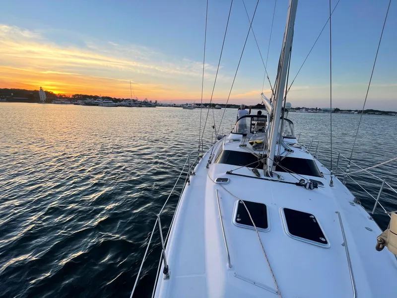Slide: The Image of Sailing on a 2009 Hunter 50 Center Cockpit yacht at sunset, calm waters. - 9